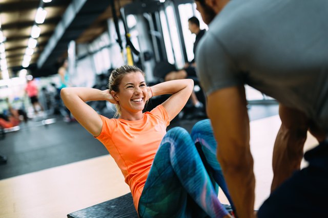 woman training with her personal trainer in the gym