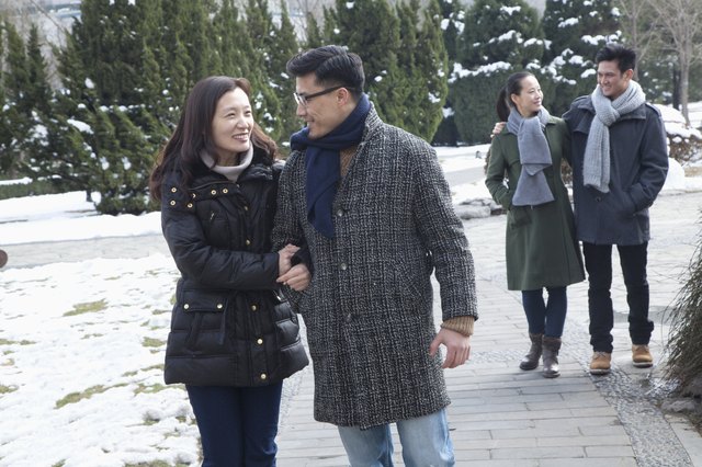 Couples in park covered in snow