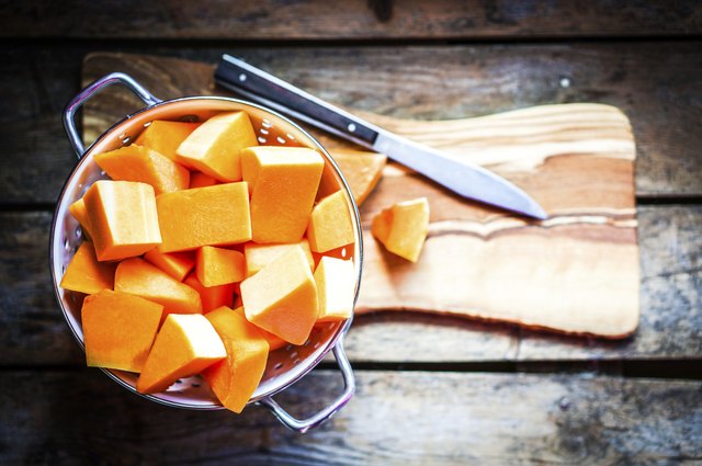 Fresh cut pumpkin on rustic wooden background