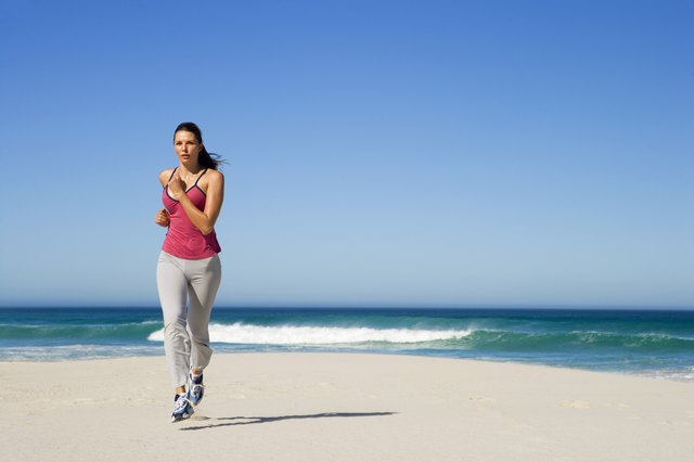 A woman running on the beach.