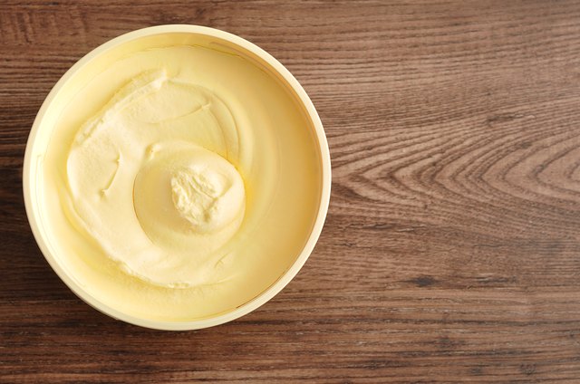 Butter isolated on a wooden background