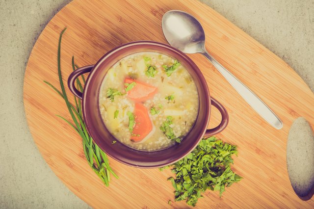Vintage photo of traditional barley soup with parsley in bowl